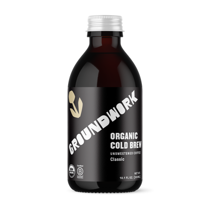 A dark brown bottle of Groundwork Coffee Co Organic Classic Cold Brew, unsweetened with a black label and white text, is shown against a black background.