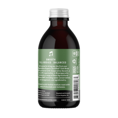 A dark glass bottle with a green label for Groundwork Coffee Co Regenerative Organic Certified® Cold Brew, featuring Smooth, Full-Bodied, Balanced notes and sustainability info.