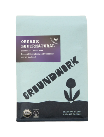 Light blue bag of Groundwork Coffee's Seasonal Select: Supernatural, a light roast with chocolate and strawberry notes, flower art, and certification badges.