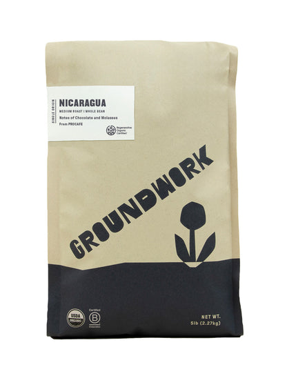 A 5 lb bag of Groundwork Coffee’s Regenerative Organic Certified® Nicaragua PROCAFE whole beans features chocolate and molasses notes and a simple tan-and-black design with a flower graphic.