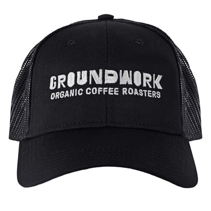 The black Groundwork Trucker Hat by Groundwork Coffee features a mesh back and white "GROUNDWORK ORGANIC COFFEE ROASTERS" embroidery on the front.