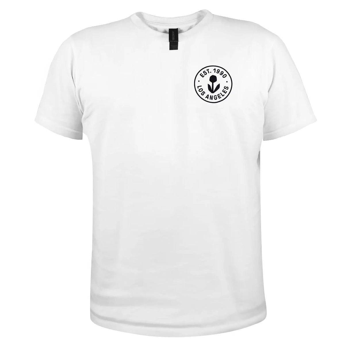Photo of a white T-shirt with a small circular Groundwork logo on the left chest that reads EST. 1990 LOS ANGELES around a black flower icon.