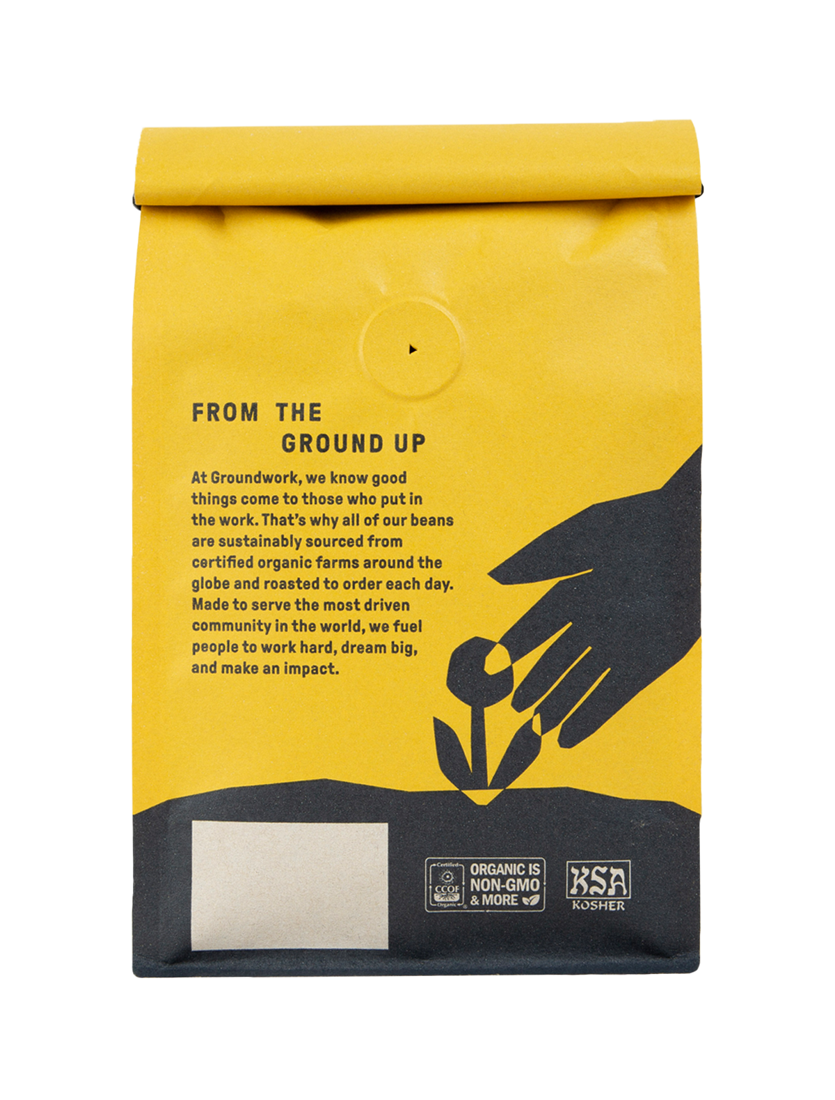 A yellow Big Shot coffee bag by Groundwork Coffee shows black graphics of a hand and sprout, medium roast profile, and organic and kosher logos at the bottom.