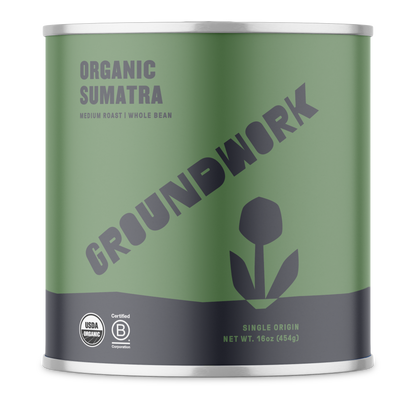 A green canister of Groundwork Coffee Stores Sumatra: Gayo Buana Mandiri whole bean coffee, with a flower logo and certification symbols on the front.