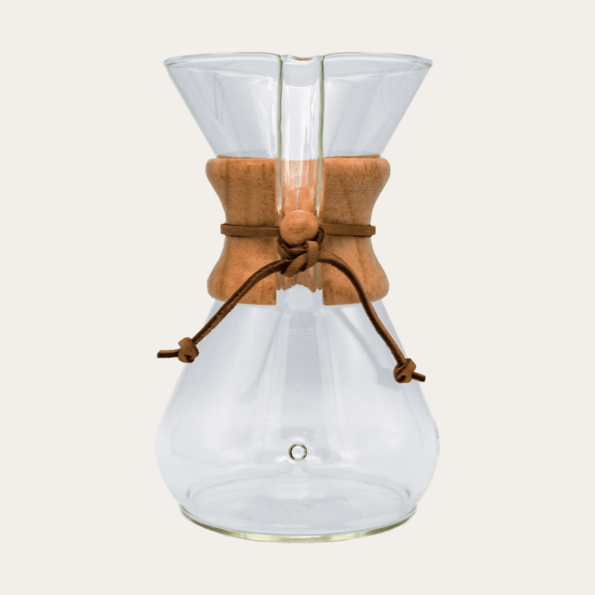 The Chemex Brewer from Groundwork Coffee features a glass body, wooden collar, and leather tie, using conical filters, shown on a plain light background.